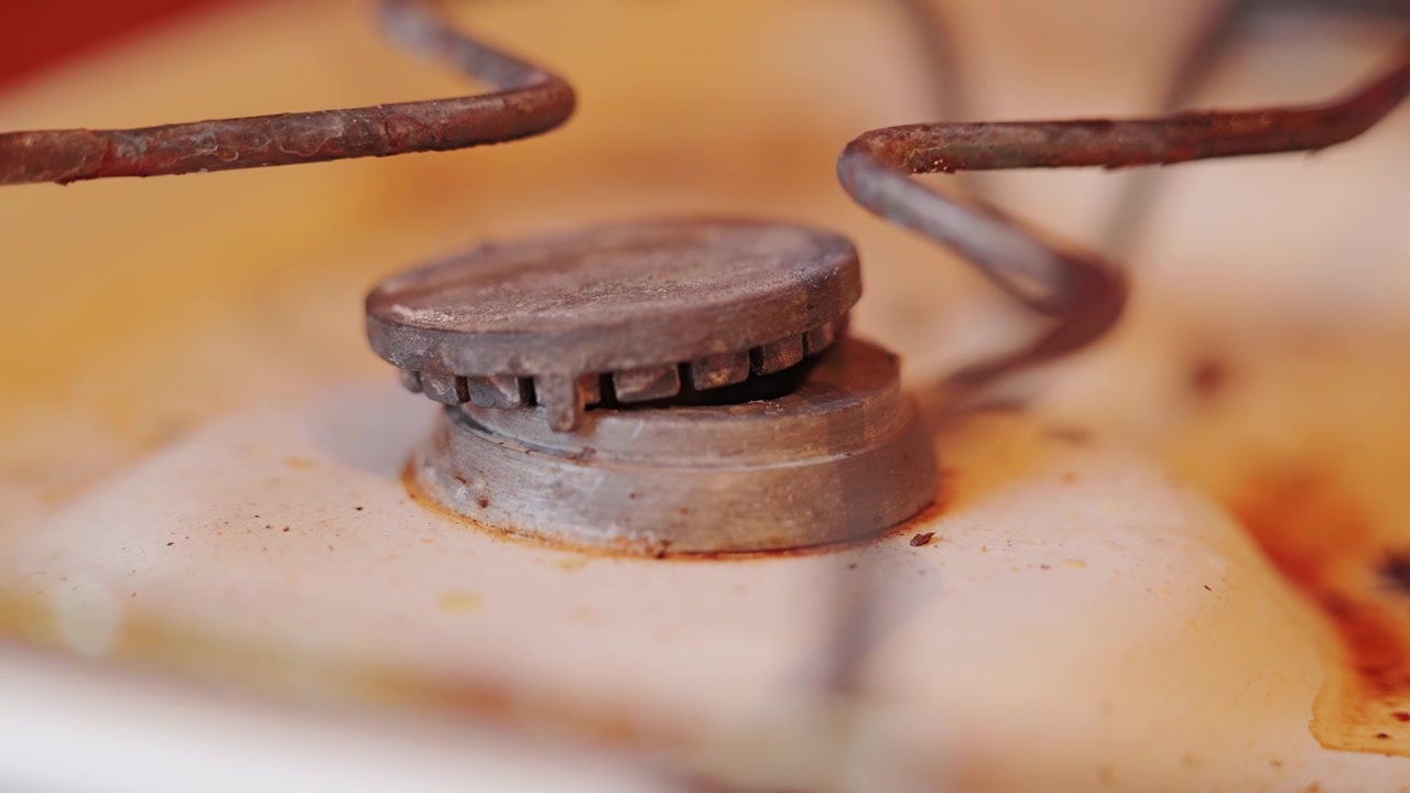 Aging kitchen appliance reveals authentic wear, grime and forgotten daily routine.