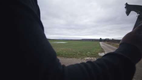 Modern-Black-Swordsman-Warrior-Awaiting-Battle-Opponent-in-Open-Field-Under-Grey-Sky,-Europe,-4K-|-Muscular,-Intimidating,-Shadow,-Figure,-Blurry,-Dark-Clothes,-Powerful,-Close-Up,-Arm,-Waiting,-Hand