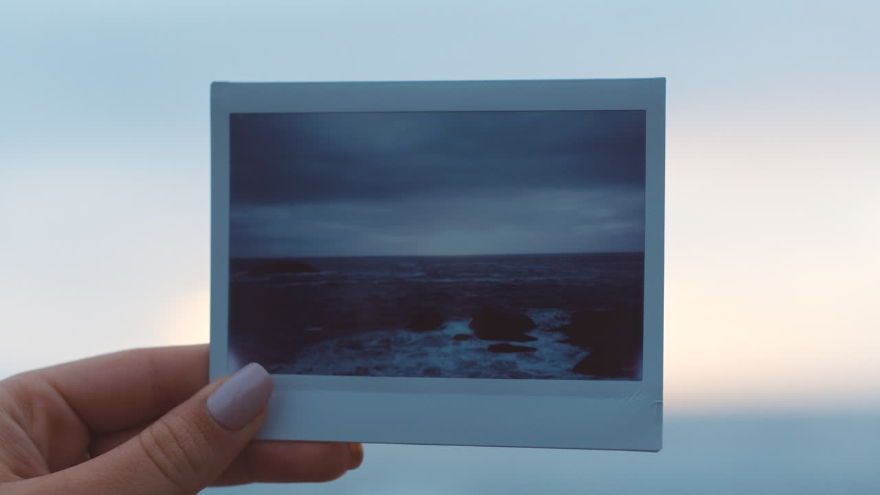 Hands, nature and photograph of a sea in the hand
