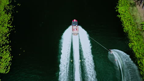 Top-Down-View-of-Waterskier-Pulled-by-Boat-on-Resort-Lake