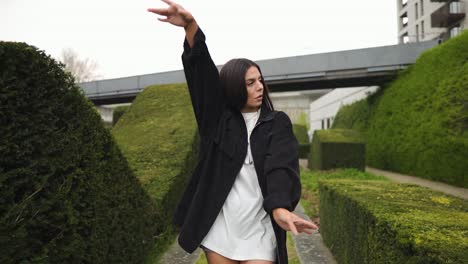 flawless dancer model with big eyes walking wearing golden jewellery and black jacket showing different types of poses very confident enjoying her time in nature cloudy settings