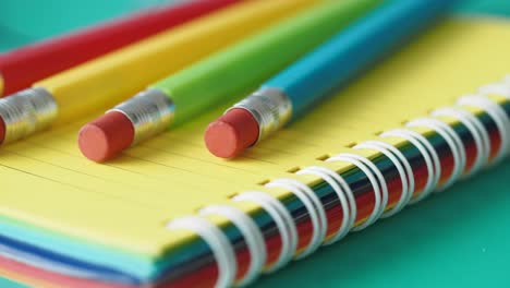 colorful pencils on a spiral notebook