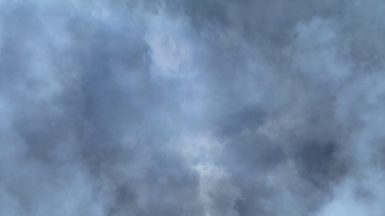 The point of view of lightning striking inside the dark moving clouds