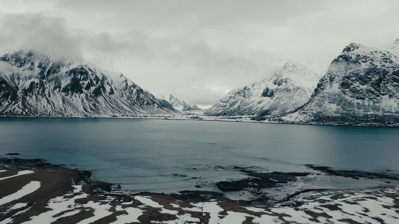 Panorama Of Snowy Mountains And Tranquil Sea During Winter Near Flakstad In Lofoten Islands, Nordland, Norway. - aerial shot
