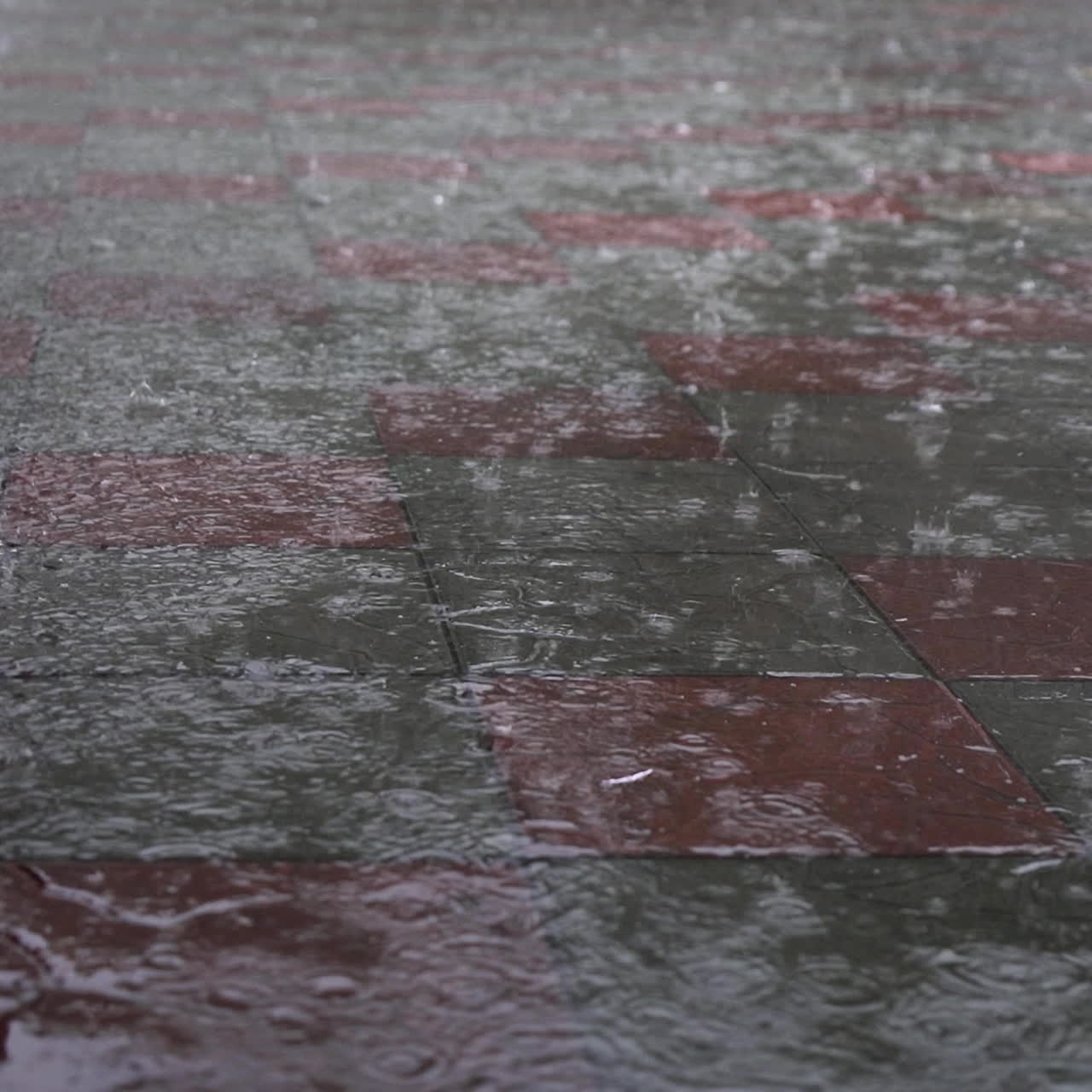 Raining drop on concrete floor in rainy day.