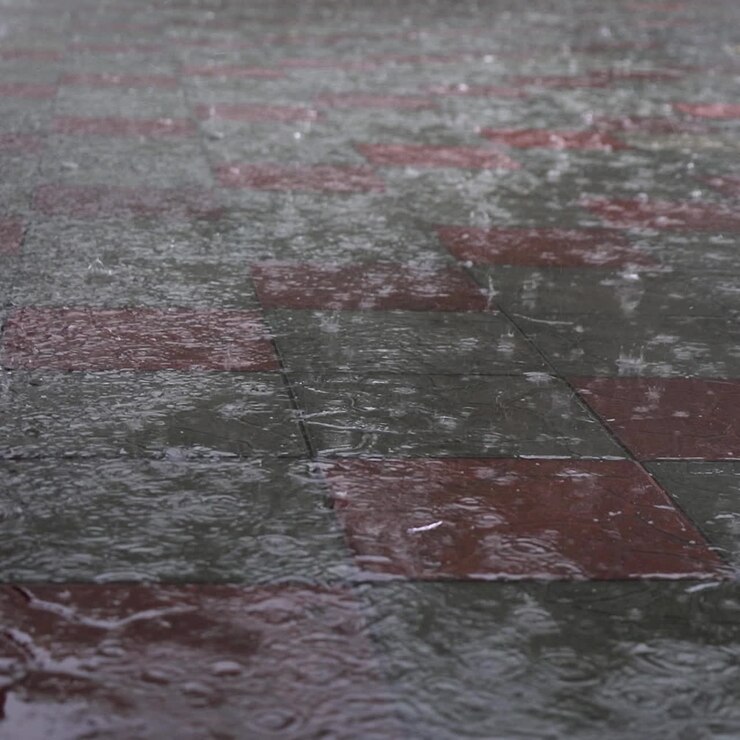 Raining drop on concrete floor in rainy day.