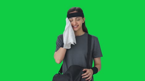 Happy-Indian-girl-taking-out-towel-from-duffel-bag-Green-screen