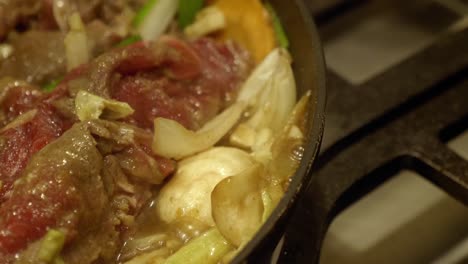 korean dish simmers in a pan over stove at the kitchen