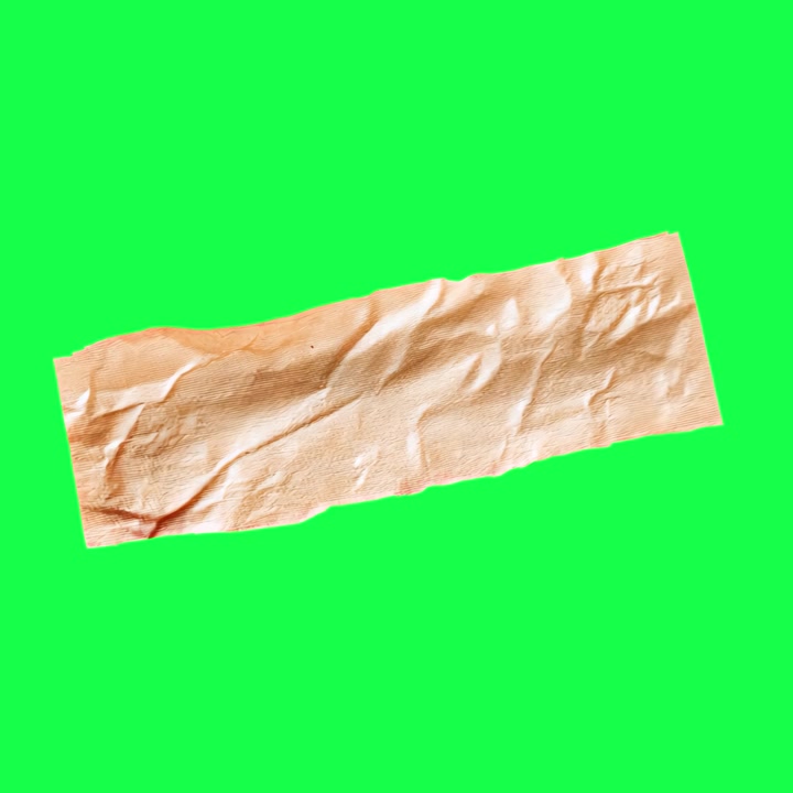 A Strip of Beige Adhesive Tape on a Green Screen Background