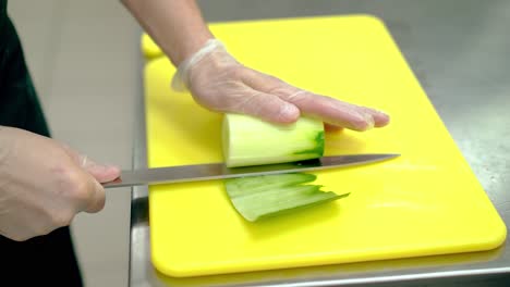 cu cook cleverly cuts the skin of the fresh cucumber with a knife