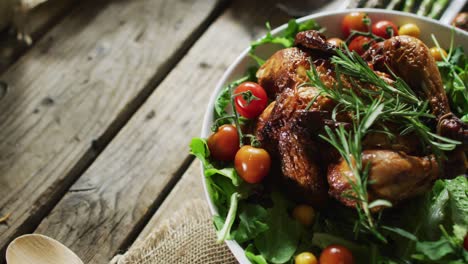 close up view of cooked chicken and multiple food ingredients on wooden surface