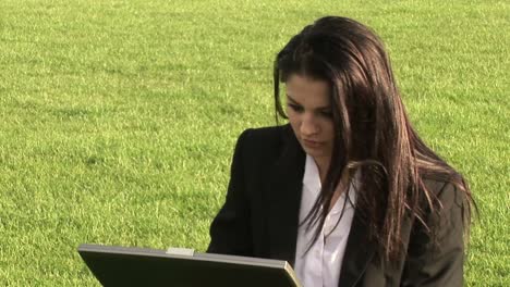 business woman working outdoors on laptop