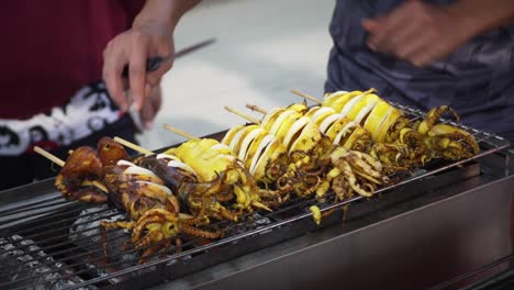 close up grilling squid on barbecue