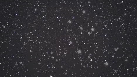 animación de nieve cayendo sobre las estrellas sobre fondo negro