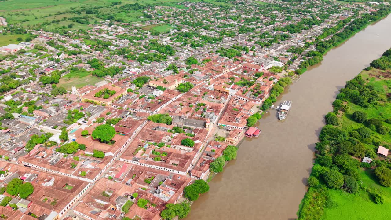 High altitude drone backward footage showing the historic colonial town of mompox on the magdalena river