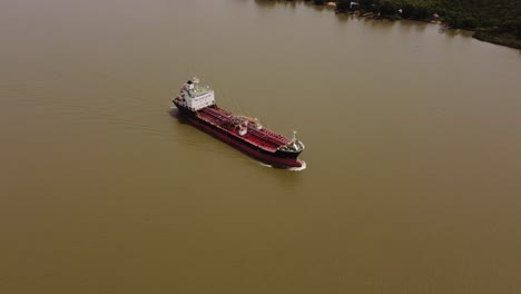 panoramic approaching view of large cargo ship of oil products tanker sailing by amazon river