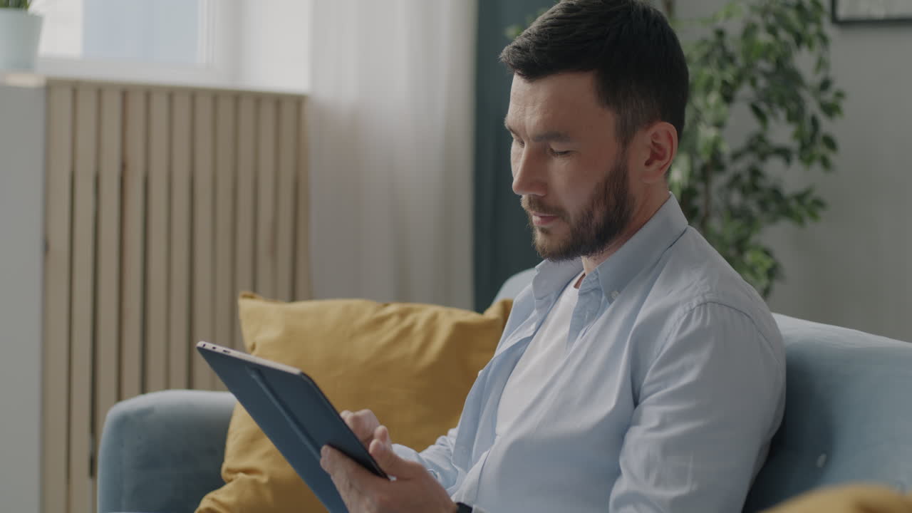 Man using a tablet on a couch