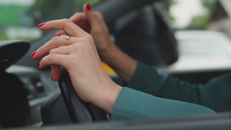 angry woman hits steering wheel of automobile with hands