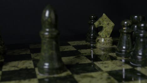 chess pieces on a green marble board