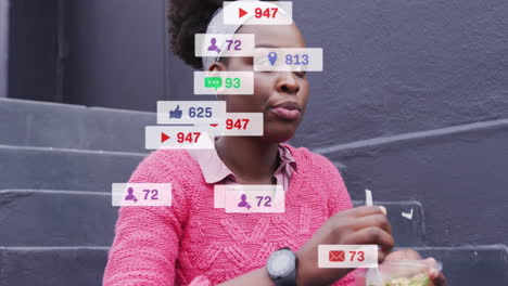 animation of social media notifications over african american woman eating takeaway in city