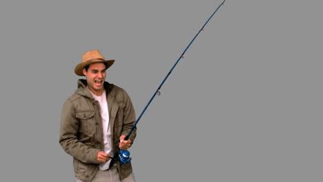 man making effort while fishing on grey screen