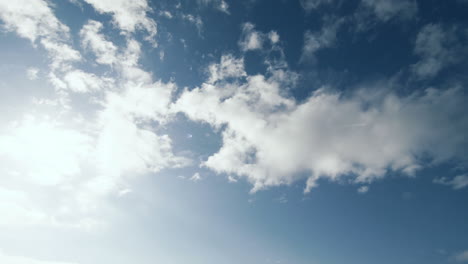 Arrows-pointing-down-against-blue-sky