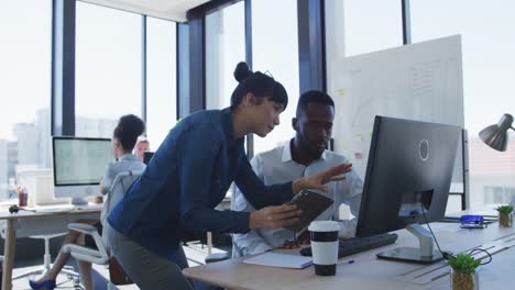 young man and woman working on computer