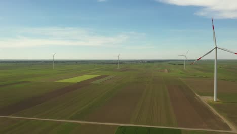 view of several windmills, wind generators, turbines, producing renewable clean energy by converting kinetic energy