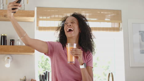 woman in kitchen enjoying fresh smoothie, wearing smartwatch and casual attire, at home