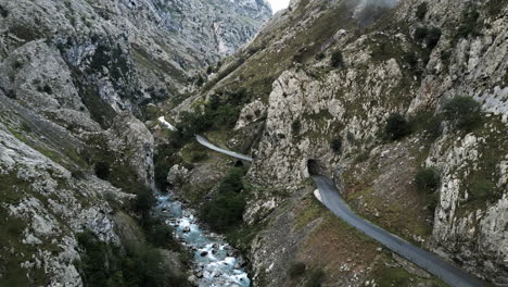 drone sweep of valley road in the northern mountains of covadonga, spain