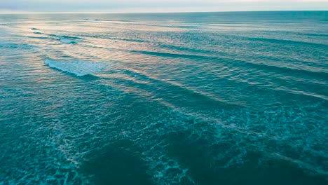 在日落時,海浪撞擊海灘