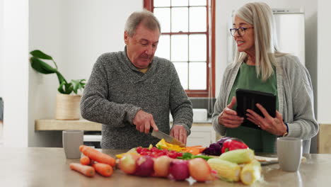 old couple in kitchen, cooking with tablet