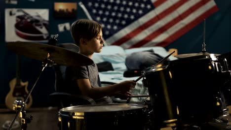 boy playing drums in bedroom