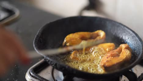 frying fish in a pan