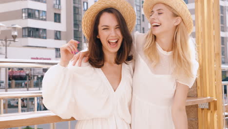 two happy women laughing outdoors