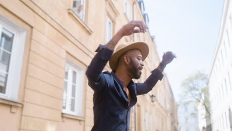 Smiling-Afro-Caribbean-Man-With-Panama-Hat-Dancing-Salsa-Alone-In-Street-4