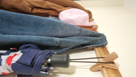 clothing and accessories on a wooden rack