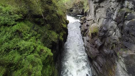 bordalsgjelet gorge in voss norway - forward moving aerial with slow tilt up above river - popular tourist attraction