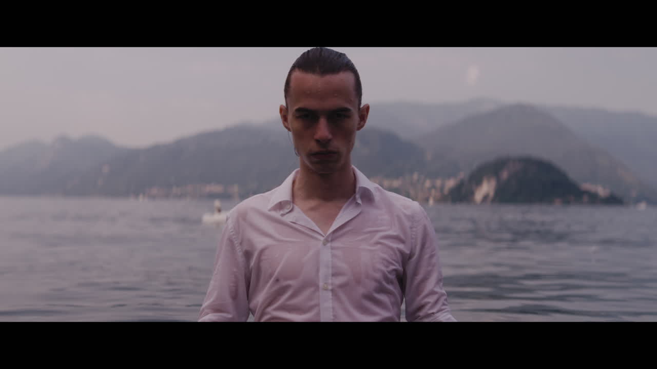 Man in Wet Shirt by Lake