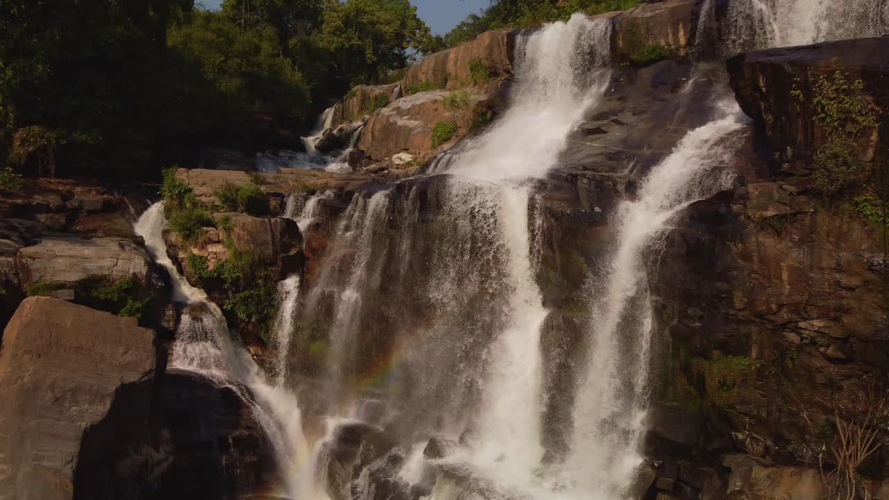 Aerial view of Mae Klang Waterfall in Doi Inthanon National Park, Thailand, cascading over rocks and surrounded by lush green jungle in the mountainous region near Chiang Mai.