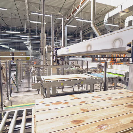 modern equipment for automating wood processing at the factory. making parquet with the help of robotic technology and people.