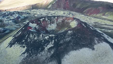 aerial reverse view of red and green colored icelandic volcano that is a captivating and geologically significant features of the highlands