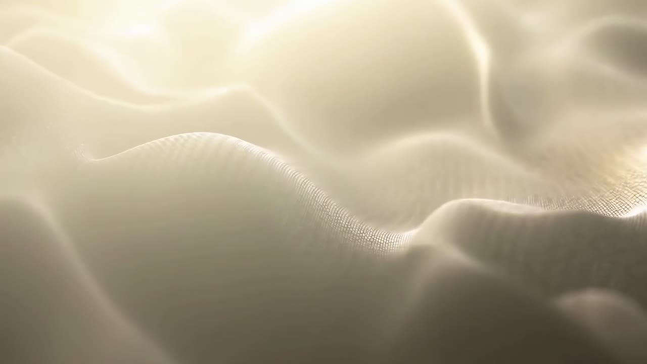 Close-up video of smooth, flowing fabric texture with soft lighting and gentle waves