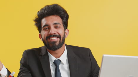 Close-up-businessman-freelancer-at-office-workplace-working-on-laptop-computer-sends-online-messages