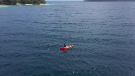 man kayaking in the middle of the beach of san pablo island, southern leyte, philippines