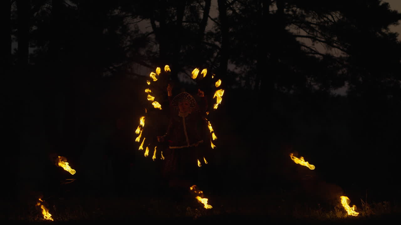 Fire Juggler Performance in the Woods at Night