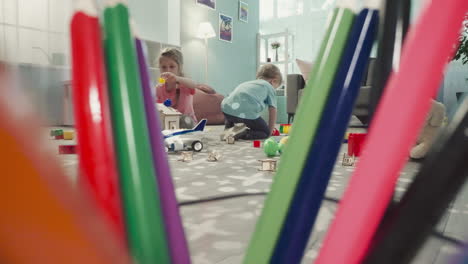 sister and brother decorate roof of wooden house in nursery