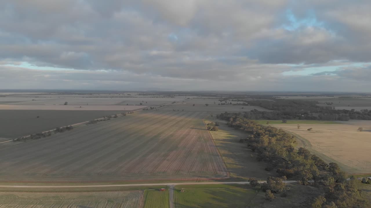 Aerial shot showing green fields of agricultural land in outback country Australia.