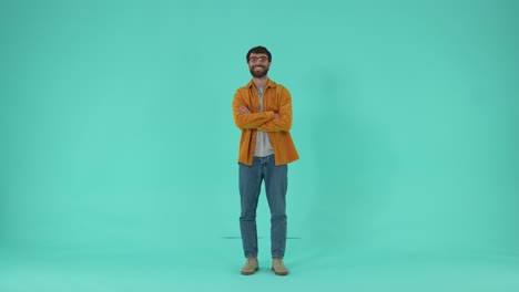 smiling bearded man crossing arms over chest