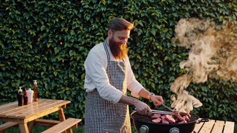 man grilling steak in backyard